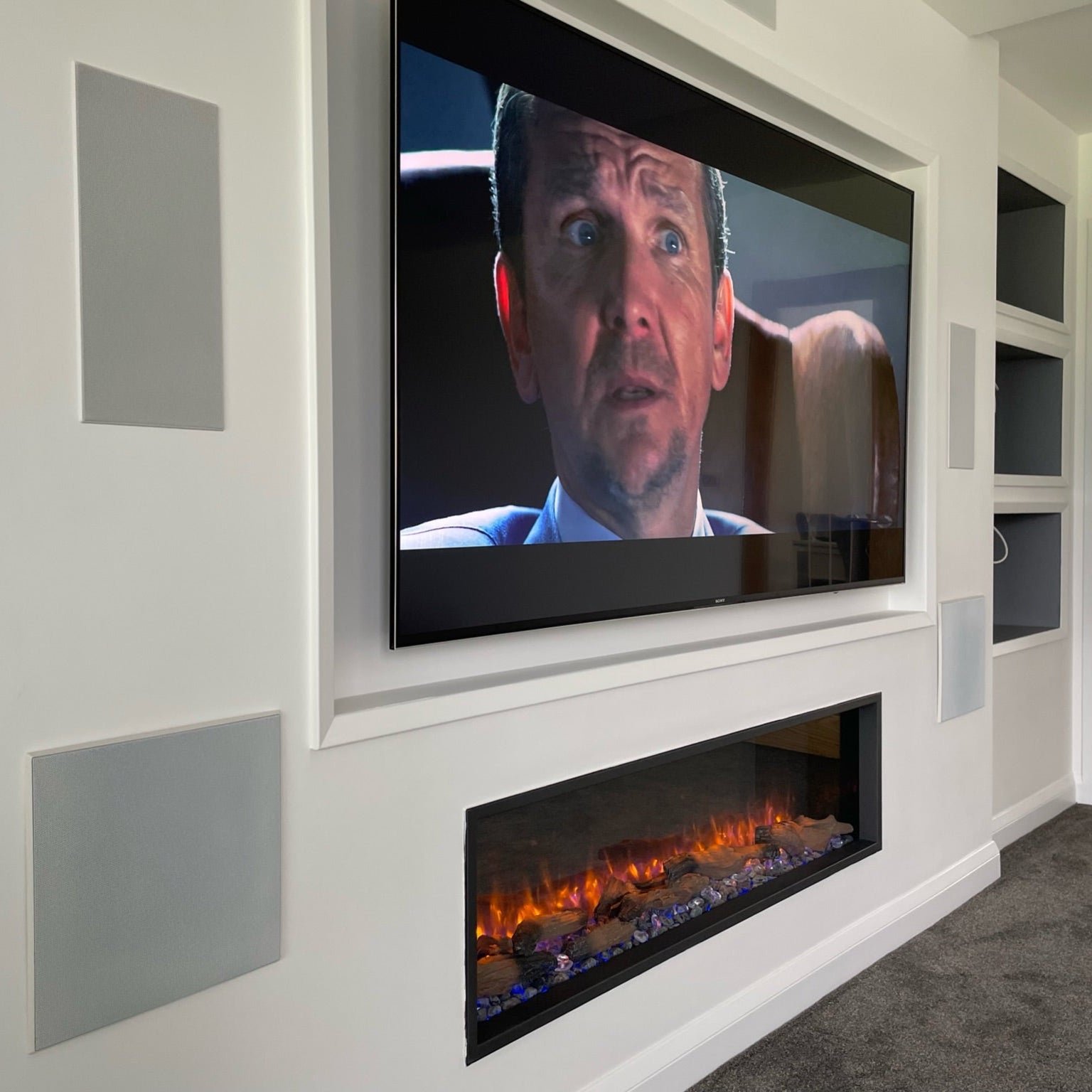 Media Wall installation with recessed TV and in wall dolby atmos home cinema system at Emotive AV Cornwall